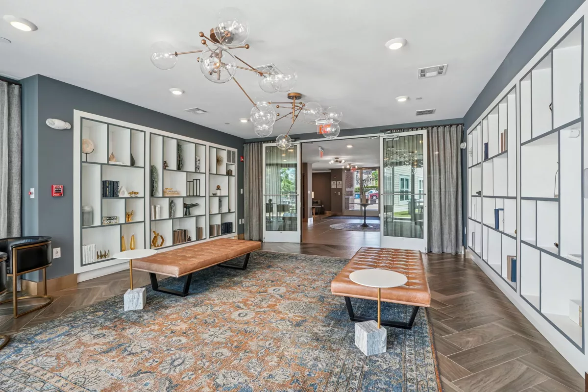 Lounge area with display shelves, leather benches, and stylish lighting fixtures.
