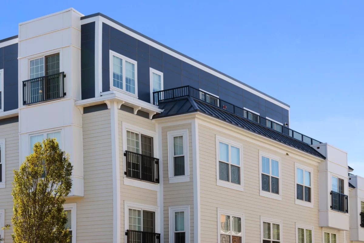 Closeup of the top of The Bradford at Belmont's large windows and rooftop deck